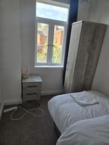 a bedroom with a bed and a window at Balfour house III in Leicester