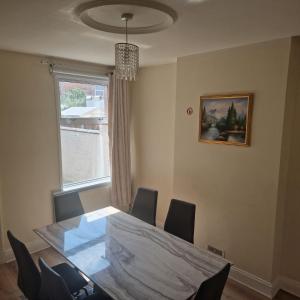 a dining room with a table and chairs and a window at Balfour house III in Leicester