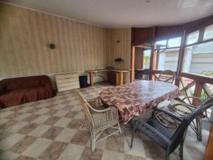a living room with a table and chairs and a couch at Full relax in Zatoka