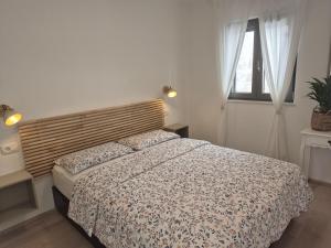 a bedroom with a bed and a window at Mareya Premium Stay in Poreč