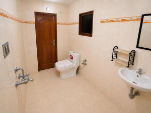 a bathroom with a toilet and a sink at Hotel Rudra Ganga View Near Temple in Varanasi