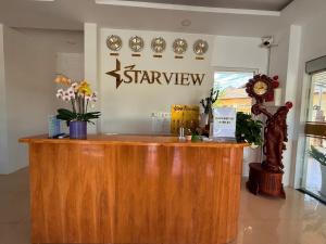 a counter in a store with a sign on the wall at Starview Villa Dalat in Da Lat