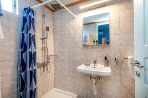 a bathroom with a sink and a shower at Malandris Studios in Skala Marion
