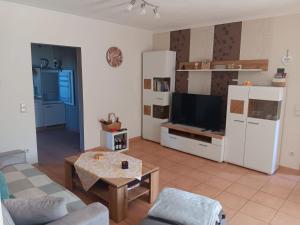 a living room with a couch and a table at Hunsrücktraum in Mittelstrimmig