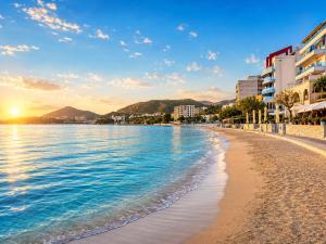 a beach in a city with buildings and the ocean at Libertina Rafailovici in Rafailovici
