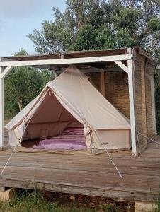 a tent sitting on a wooden deck at Macarìa Agricampeggio in Alliste