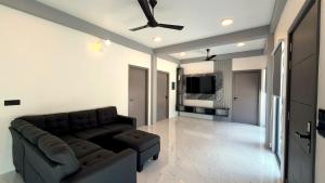 a living room with a couch and a ceiling fan at Ahiva Suites Goidhoo in Fehendhoo