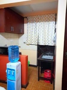 a small kitchen with a table and a small table at Sifa Stays in Ongata Rongai 
