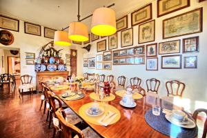 a dining room with a large wooden table and chairs at Il Principe by PosarelliVillas in Marsiliana