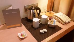a counter with a coffee maker and a telephone on it at Hotel Barcelona Universal in Barcelona
