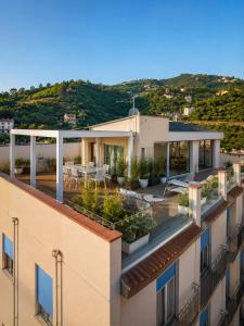 a view of a building with a patio on the roof at Home del Corso in Capo dʼOrlando