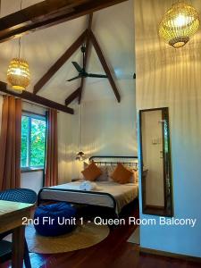 a bedroom with a bed and a mirror at Wayans Siargao Homestay in General Luna