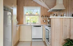 a kitchen with a white refrigerator and a window at Awesome Home In Ulfborg With Wifi in Ulfborg