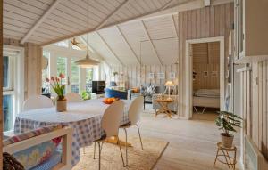 a dining room and living room with a table and chairs at Awesome Home In Ulfborg With Wifi in Ulfborg