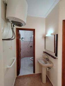 a bathroom with a sink and a toilet and a mirror at Villa Perle Bleu in Saïdia +15 photos