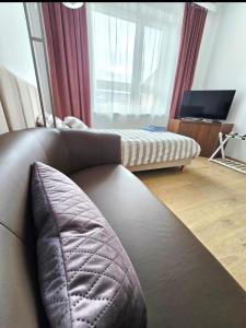 a living room with a couch and a large window at Perłowy in Biłgoraj