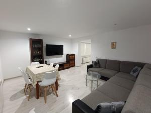 a living room with a couch and a table at Kowolove in Bańska Wyżna