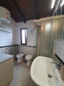 a bathroom with a sink and a toilet and a sink at Villa Maris in Nebida