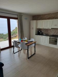 a kitchen with a table and chairs in a room at Villa Maris in Nebida