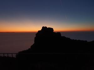 a silhouette of a mountain at sunset at Villa Maris in Nebida