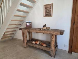 a wooden table with shoes on it in a room at Au petit soulier de Puisaye in Treigny
