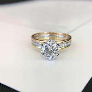 a gold engagement ring with a diamond on a table at Antiquecut Jewelry in Surat