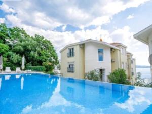a large blue swimming pool in front of a building at Adriadome Sky in Bijela