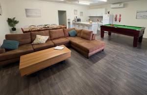 a living room with a couch and a pool table at Roantree House in Portland