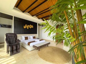 a bedroom with a bed and a chair and a table at Depari Dago Villa in Bandung +70 photos