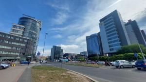 a city with cars parked on a street with tall buildings at Metro Budějovická apartment in Prague