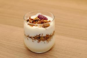 a glass of milk with nuts and a raspberry on top at Casa Doña Carmela GuestHouse - parking included in Santa Cruz de Tenerife +44 photos