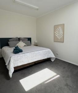 a bedroom with a large bed in a white room at Roantree House in Portland