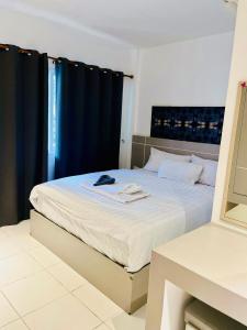 a bedroom with a large bed with a black curtain at SET INN restaurant & bar 1 & 2 in Kata Beach