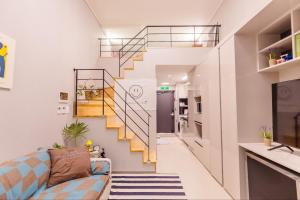 a living room with a staircase and a couch at 썸원호텔 in Yŏsu
