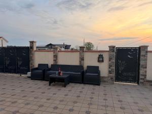 a patio with couches and a table and a sunset at Nistor House-Delta Retreat in Tulcea