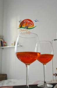 two glasses of wine sitting on a table at B&B Dimora Lucia e Dalila in Conversano