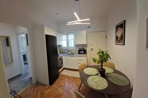 a kitchen and dining room with a table and chairs at Lemon House in Athens