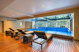 a large living room with a pool and chairs at Fortune Park Dalhousie - Member ITC Hotels' Group in Dalhousie