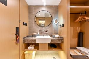 a bathroom with a sink and a mirror at Atour S Hotel Beijing Anzhen in Beijing +49 photos