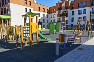 a playground in a city with colorful playground equipment at Apartament Pod Modrzewiem in Augustów