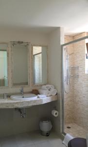 a bathroom with a sink and a shower at Villa Lefka in Kastrosikia