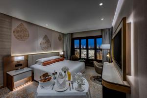a hotel room with a bed and a television at Makkah Hotel in Mecca +140 photos