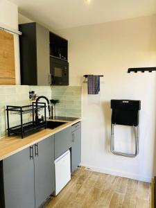 a kitchen with a sink and a counter top at Appart'Hotel au Pradet in Le Pradet +1 photo