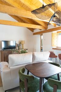 a living room with a couch and a table at Casa Molivez Apartamento Fabregas in Alhama de Granada