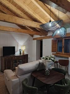 a living room with a couch and a table at Casa Molivez Apartamento Fabregas in Alhama de Granada