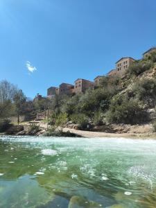 a view of a river with buildings on a hill at Casa río de Bolbaite in Bolbaite
