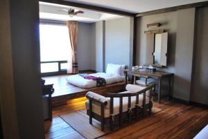 a living room with a bed and a table at Haven Resort Paro in Paro