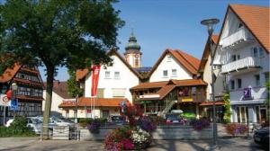 a town with buildings and a clock tower at Hotel am Hindenburgplatz in Appenweier
