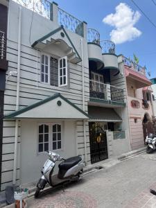 a scooter parked in front of a building at The Green residence in Mysore