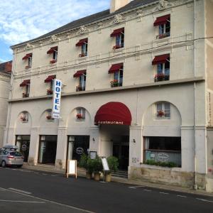 a large white building with red awnings and windows at Hôtel L'Univers in Châtellerault